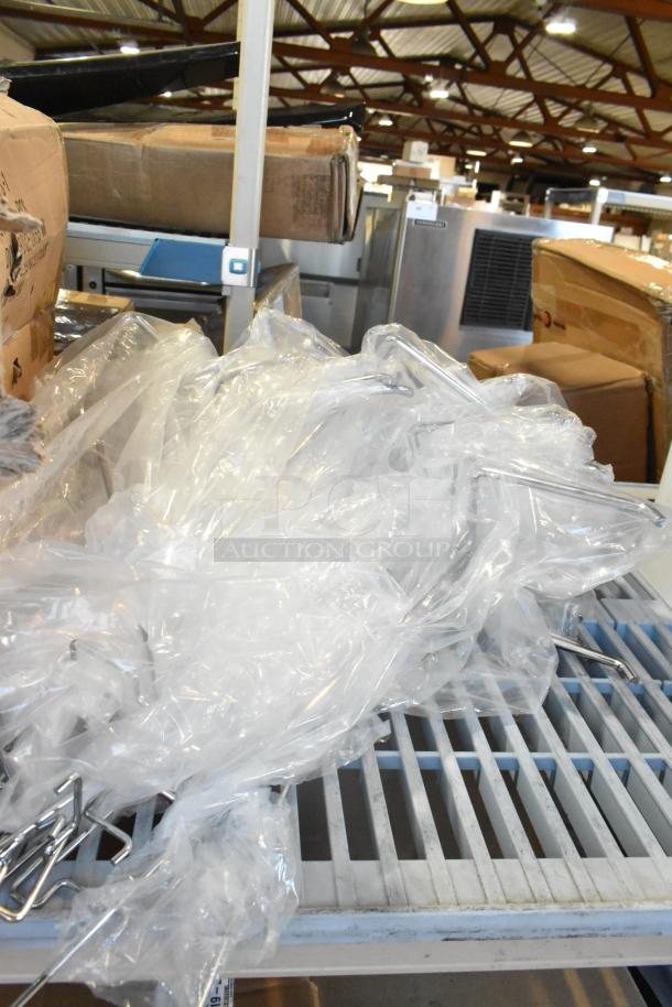 Lot of various new items including Uline S-1717 polypropylene strapping and Firefly PS-1 in packaging on shelf.