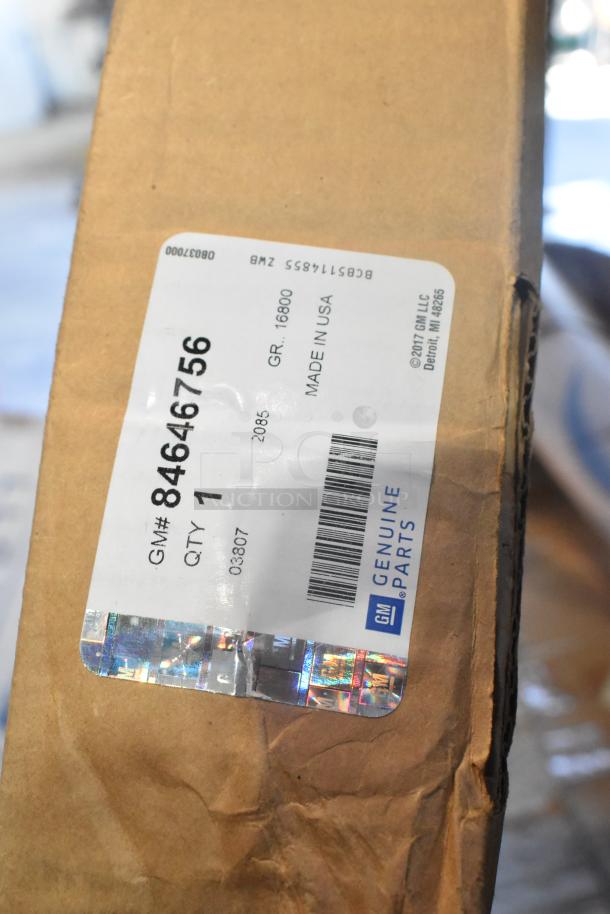 Brown cardboard box with GM Genuine Parts label, item number 84646756, made in USA. Contains 17 brand new car mats.