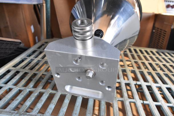 Metal hopper with a polished finish, featuring a secure mounting base and threaded inlet/outlet. Excellent condition.