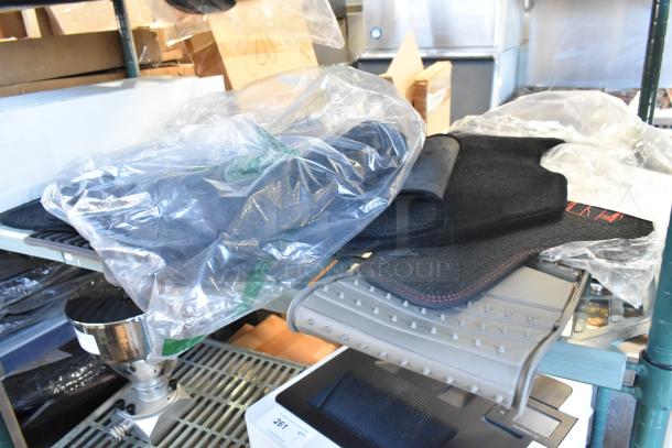 Brand new two-tier lot including packaged car mats on shelf. Various boxed items visible in background.