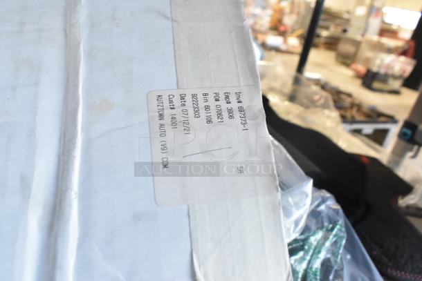 A two-tier lot of brand new items including car mats, in original packaging. Label shows inventory details.