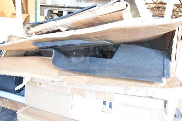 Two-tier lot with brand new items including black car mats in cardboard packaging.