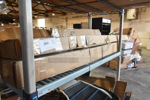 Three new boxed items with rails on warehouse shelf, labeled "264, QTY x3," indicating lot number and quantity.