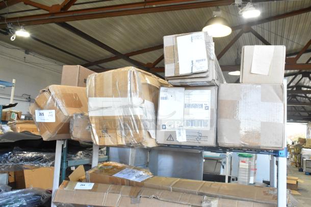 8 brand new items, including GM 84162521 and Denali floor mats, stacked in labeled cardboard boxes in a storage area.