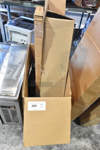 4 new items in cardboard boxes, including GM 19202164 window deflector and rain guard. Label indicates quantity 4, lot 266.