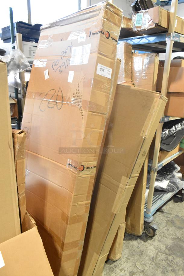 8 new GM auto parts in boxes, including GM 22950575 bumper, 22989472 spoiler kit, and 19328980 window deflector.