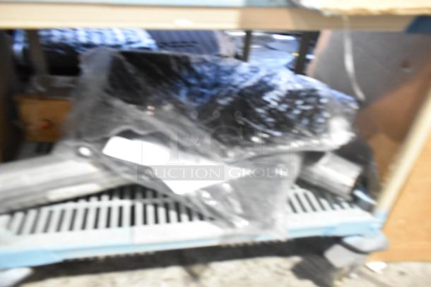 Brand new tier lot with various items, including car mats, wrapped in plastic. Ideal for buyers seeking assorted new items.