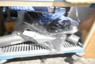 Brand new tier lot with various items, including car mats, wrapped in plastic. Ideal for buyers seeking assorted new items.