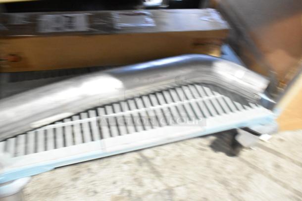 Brand new tier lot including car mats, metal pipe, and cardboard box on pallet. Items appear unused and unopened.