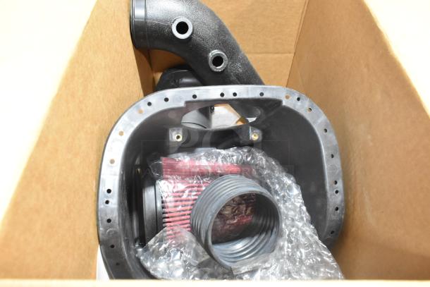 Box containing new GM 22858829 car mat and components, wrapped in bubble wrap; includes a coiled hose and plastic parts.