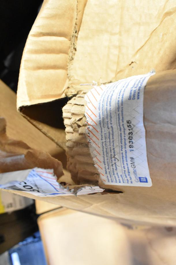 Box containing 2 brand new GM 19303155 rims in original packaging. Labels show part number and GM branding.