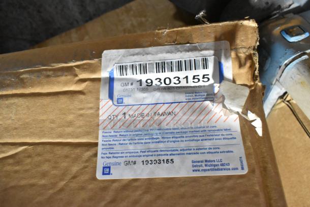 Box labeled GM 19303155 containing two brand new rims. Genuine GM part, made in Taiwan. Packaging shows minor wear.