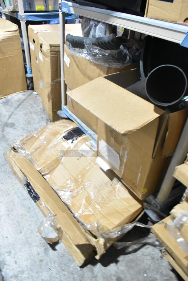 Brand new tier lot of assorted items, including car mats, in boxes on a shelf. Packaging is intact but some boxes show wear.