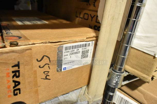 New GM car mats and Chevrolet retractable cargo shade in boxes, labeled GM# 22858823 and GM# 84449319, both genuine parts.