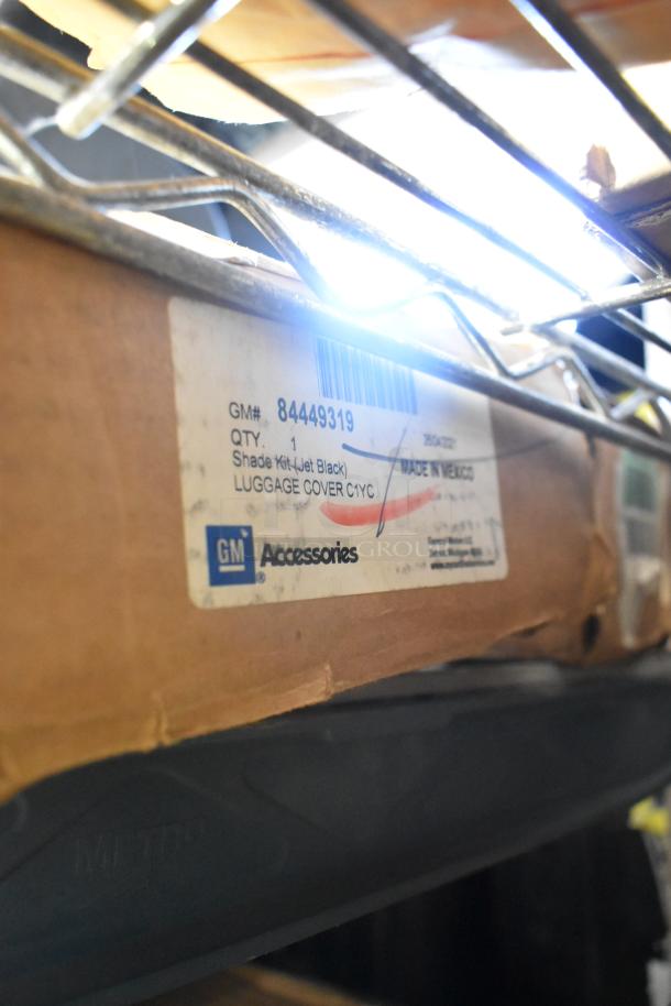 BRAND NEW GM car mats (22858823) and Chevrolet cargo shade (84449319) in packaging; labels visible.