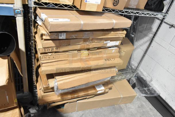 Stack of sealed boxes containing various brand new items, including GM 84370635 floor liner, on metal shelf in a warehouse.