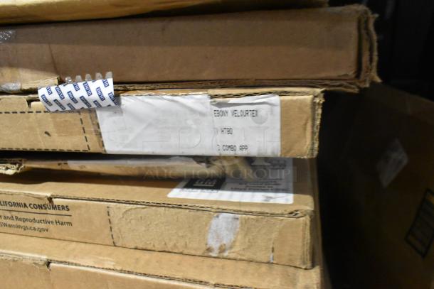 Tiered stack of cardboard boxes, including GM 84370635 floor liner. Visible label reads "Ebony Velourtex." Boxes in new condition.