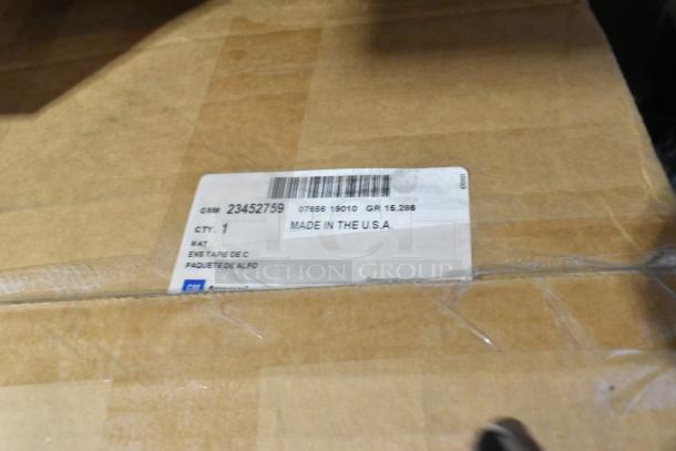 Box with label showing GM part number 23452759, indicating contents of car mats. Condition: brand new. Made in the USA.
