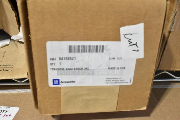 Brown box with GM 84162521 label, indicating a brand new third row all-weather rubber floor mat for Traverse, made in USA.