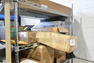 A tiered lot on a metal shelf, includes sealed boxes and packages such as a 100230A balancer and GM 23473653 TPMS valve stem caps, all brand new.