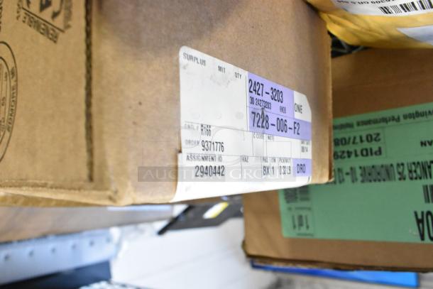 Box with item labels for a BNIB tier lot, including 100230A balancer, GM 23473653 valve stem caps; surplus label details included.