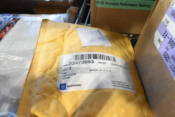 BRAND NEW tier lot including GM 23473653 Tire Pressure Monitoring Valve Stem Caps, unopened package with barcode and GM logo.