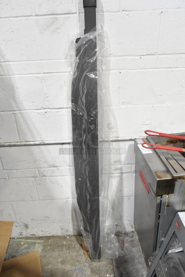 Brand new rail wrapped in plastic against a white brick wall; auction includes two items.