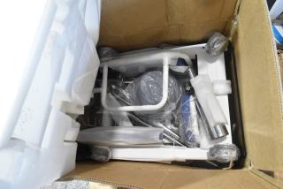 Brand new unit on casters in original packaging, surrounded by protective foam and bubble wrap, showing its pristine condition.