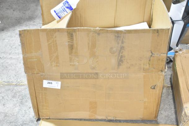 Cardboard box containing a brand new unit on casters. Box is labeled "285." Bottle of Zep disinfectant visible.