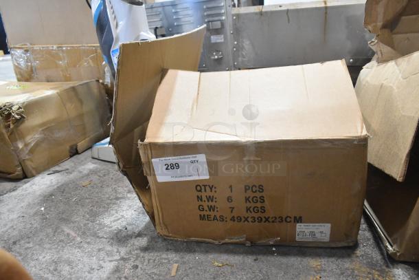 Cardboard box containing a brand new hand lawn mower. Box shows item specs: 1 piece, net weight 6 kg, dimensions 49x39x23 cm.