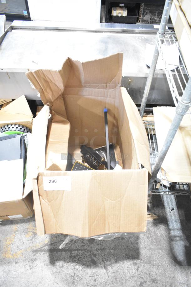 New light fixture in an open box, showing metal parts and wiring, labeled "290." Box appears in excellent condition.