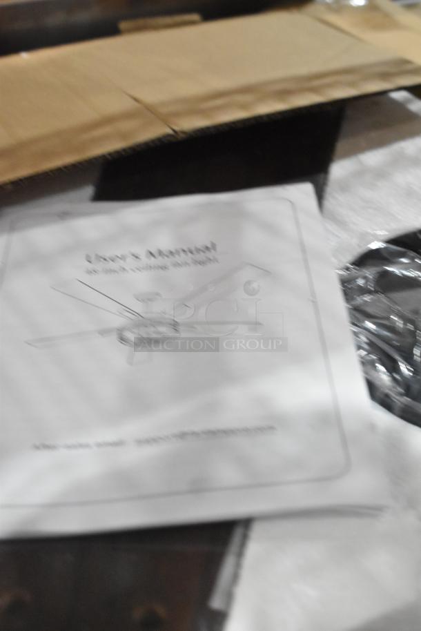 Brand new X004774KG3 Walnut Cage 48" ceiling fan with user manual visible, boxed, unopened, pristine condition.