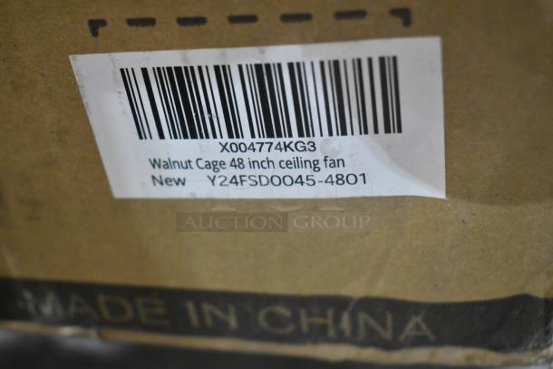 Brand new Walnut Cage 48" ceiling fan in original packaging. Model X004774KG3, made in China. Barcode label visible.