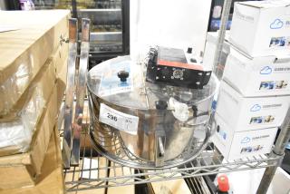 Brand new electric bud trimmer, 115 volts, 1 phase, visible scratches and dents, auction tag "296" attached.