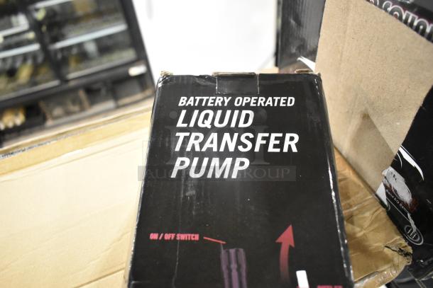 Battery-operated liquid transfer pump box, visible brand markings, slightly dented packaging.