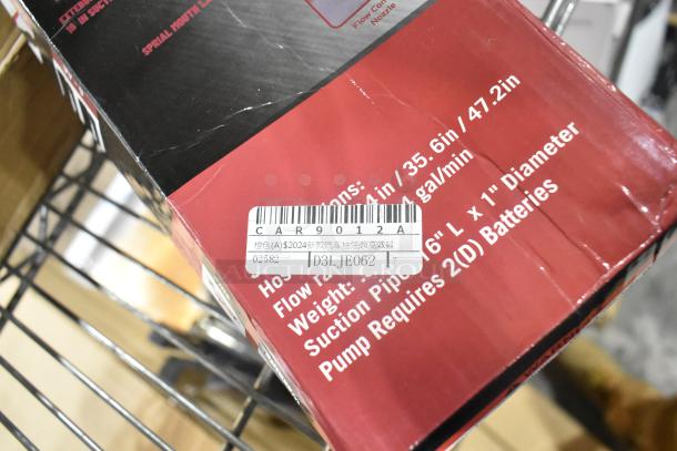 Box with visible scratch and dent, containing a liquid transfer pump. Label shows model CAR9012A and details in multiple languages.