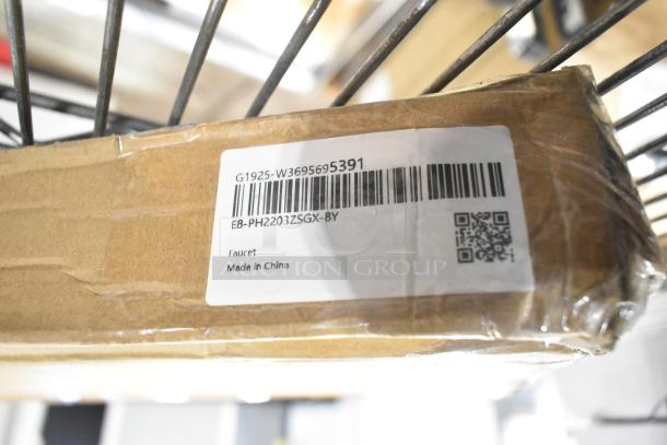 Cardboard box with label showing barcode, model E8-PH2203ZSGX-8Y, "Faucet, Made in China". Part of auction lot.