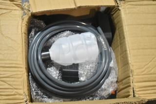 Brand new scratch and dent hose kit in open cardboard box, coiled with protective packaging, slight outer box wear visible.