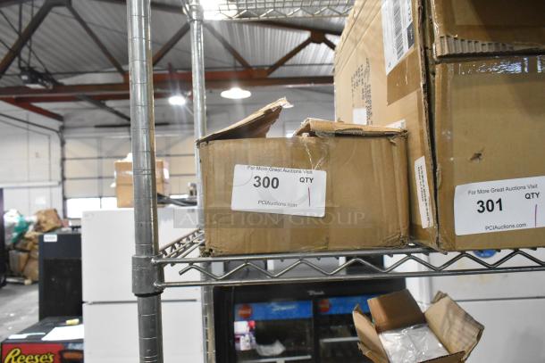 Cardboard box labeled "Hose Kit," showing damage and wear, on metal shelf. Tag reads "300 QTY" from PCIauctions.com.