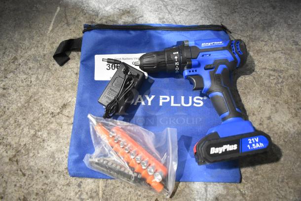 DayPlus 21V cordless drill kit with charger, bit set, and blue branded soft bag. Appears in good condition.