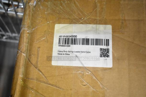 Brown box with label reading "Heavy Duty Spring-Loaded Gate Caster, Made in China." Box is sealed with clear tape.