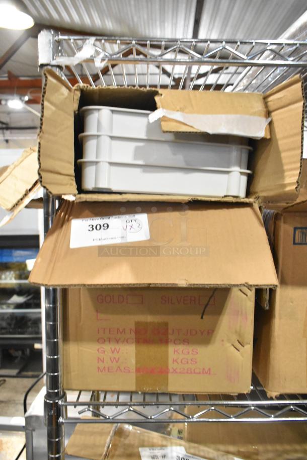 Cardboard boxes on a metal shelf containing a new juice dispenser and white cart; labeled "Scratch and Dent," QTY 2.