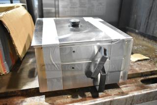 Brand new metal bin with some scratches and dents. Features sturdy handles and taped lid. Potential storage solution.