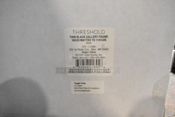 Thin black gallery frame by Threshold, 16x20 matted to 11x14, new condition. Label shows Target Corp. details and compliance info.