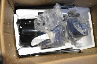 Brand new unit with scratches and dents in open box, surrounded by protective styrofoam and plastic packaging.