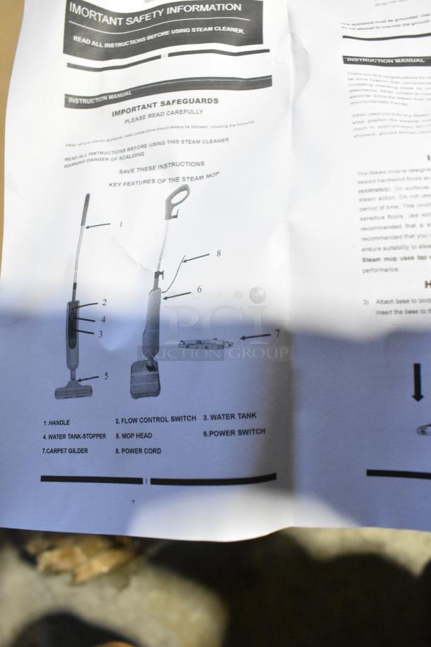 Brand new scratch and dent floor cleaner. Manual showing key features: handle, flow control switch, water tank, and mop head.