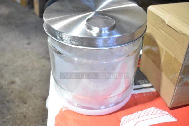Glass jar with a stainless steel lid, new condition, part of a set including food trays and wooden barrel decoration.
