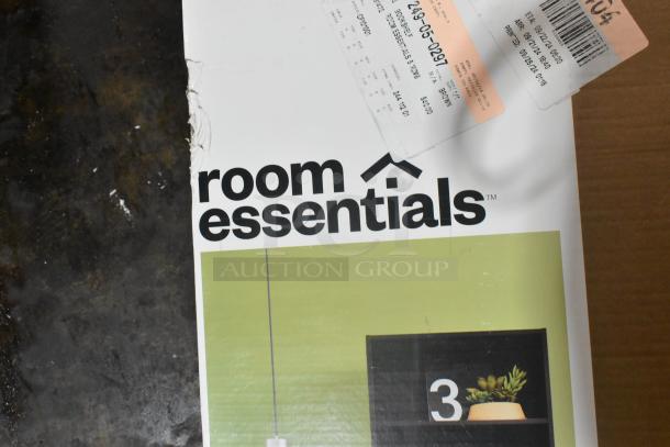 Room Essentials 5 Shelf Bookcase packaging with minor scratches. Box shows brand logo, a green background, and product price tags.