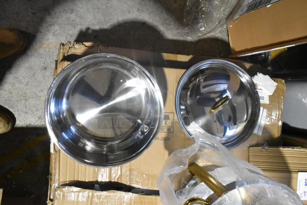 Brand new stainless steel round chafer, visible scratches and dents, gold handles, packaging on worn cardboard.