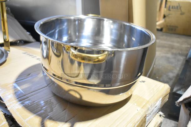 Brand new stainless steel round chafer with minor scratches, features gold-tone handles, ideal for catering events.